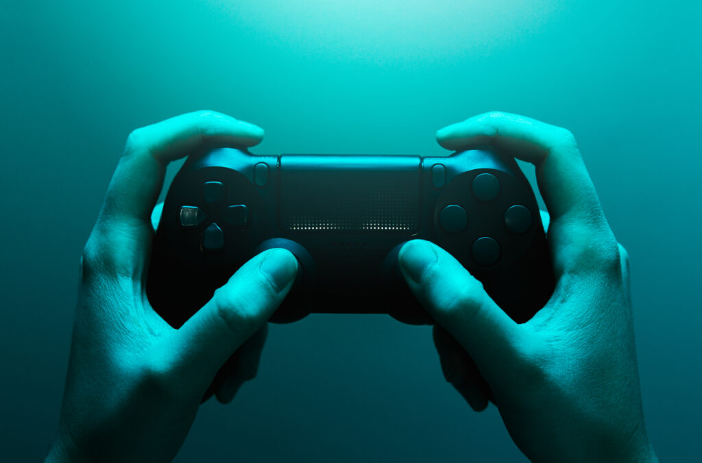 hands-holding-controller-bathed-in-blue-light-2026-03-09-03-25-10-utc